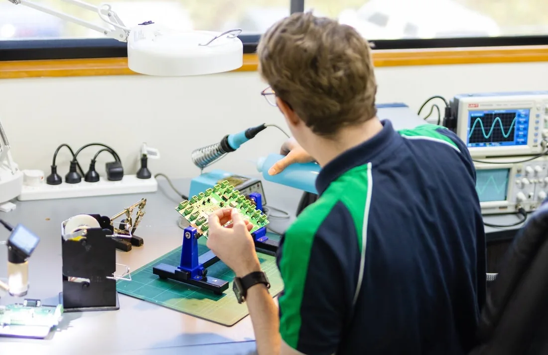 A Gas Detection Australia technician testing a gas detector circuit board at the workshop bench